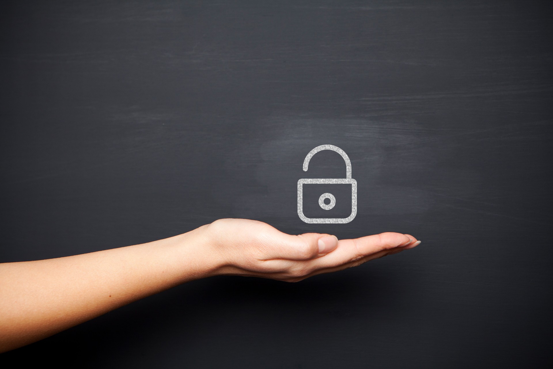 Human hand with padlock on chalkboard